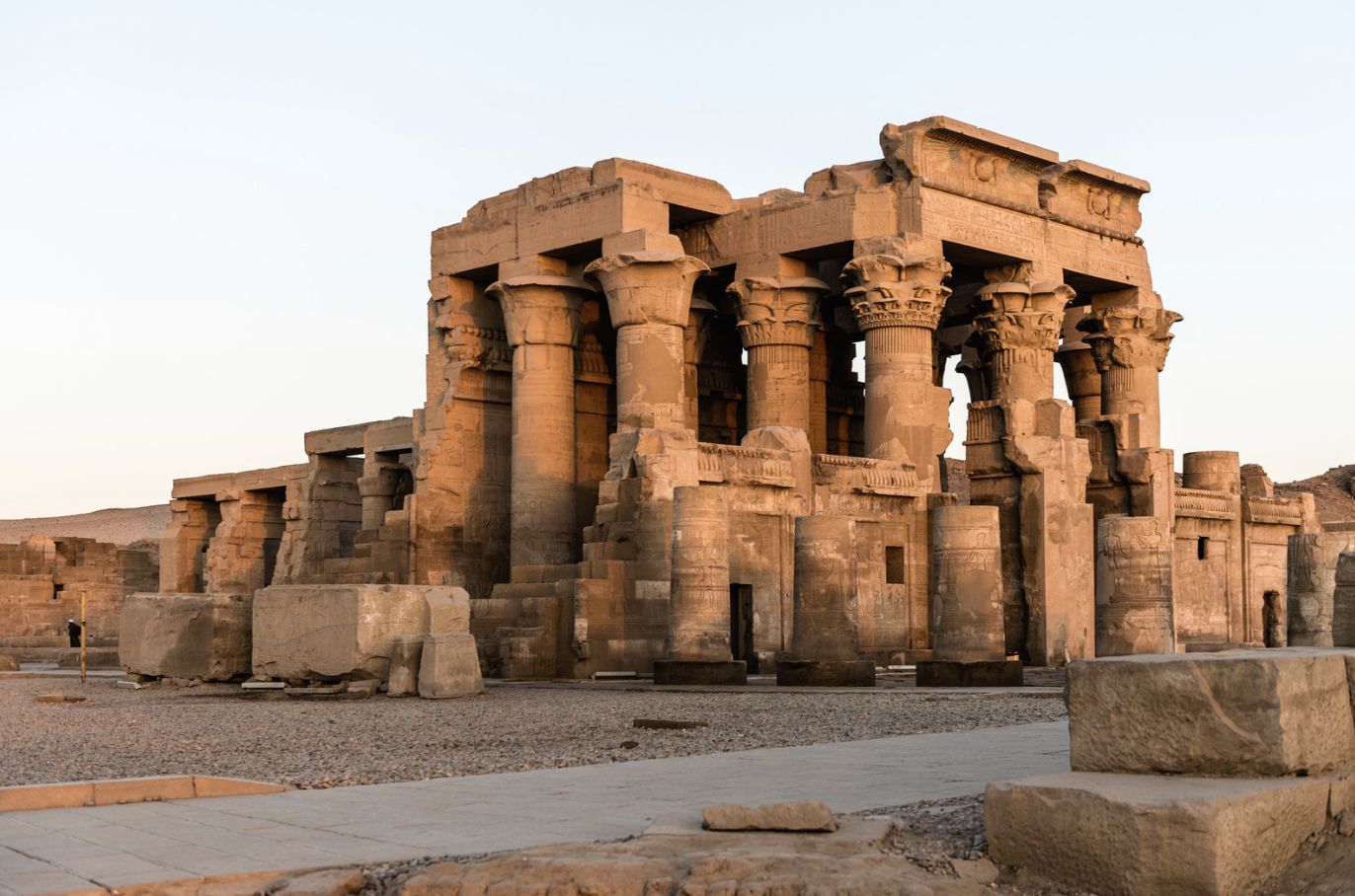 Kom Ombo Temple glowing at dusk beside the Nile