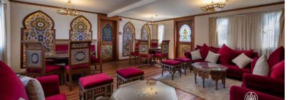 The salon aboard El Hanem, carved wood and deep red seating