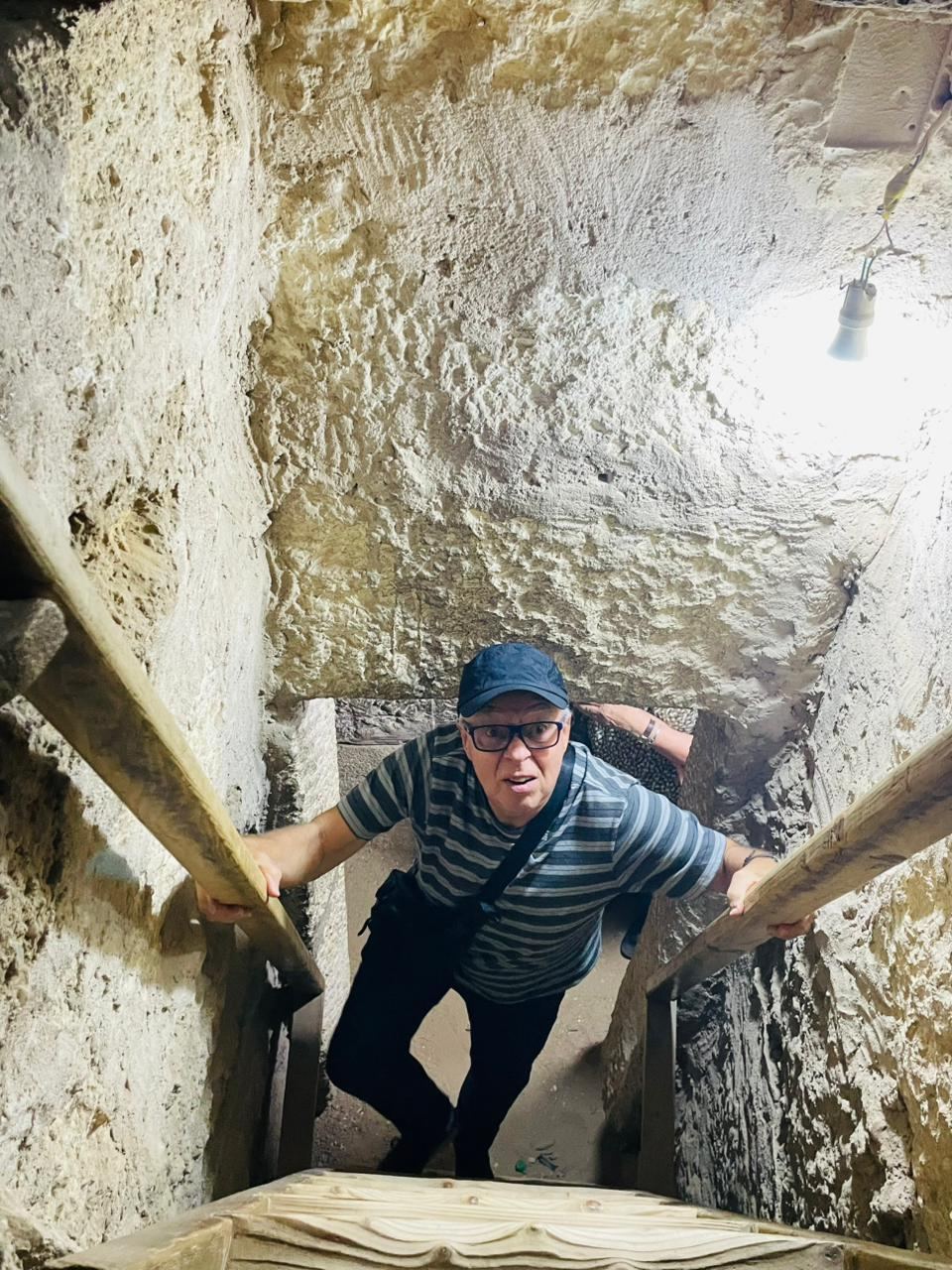 An Explorer climbing down into a tomb